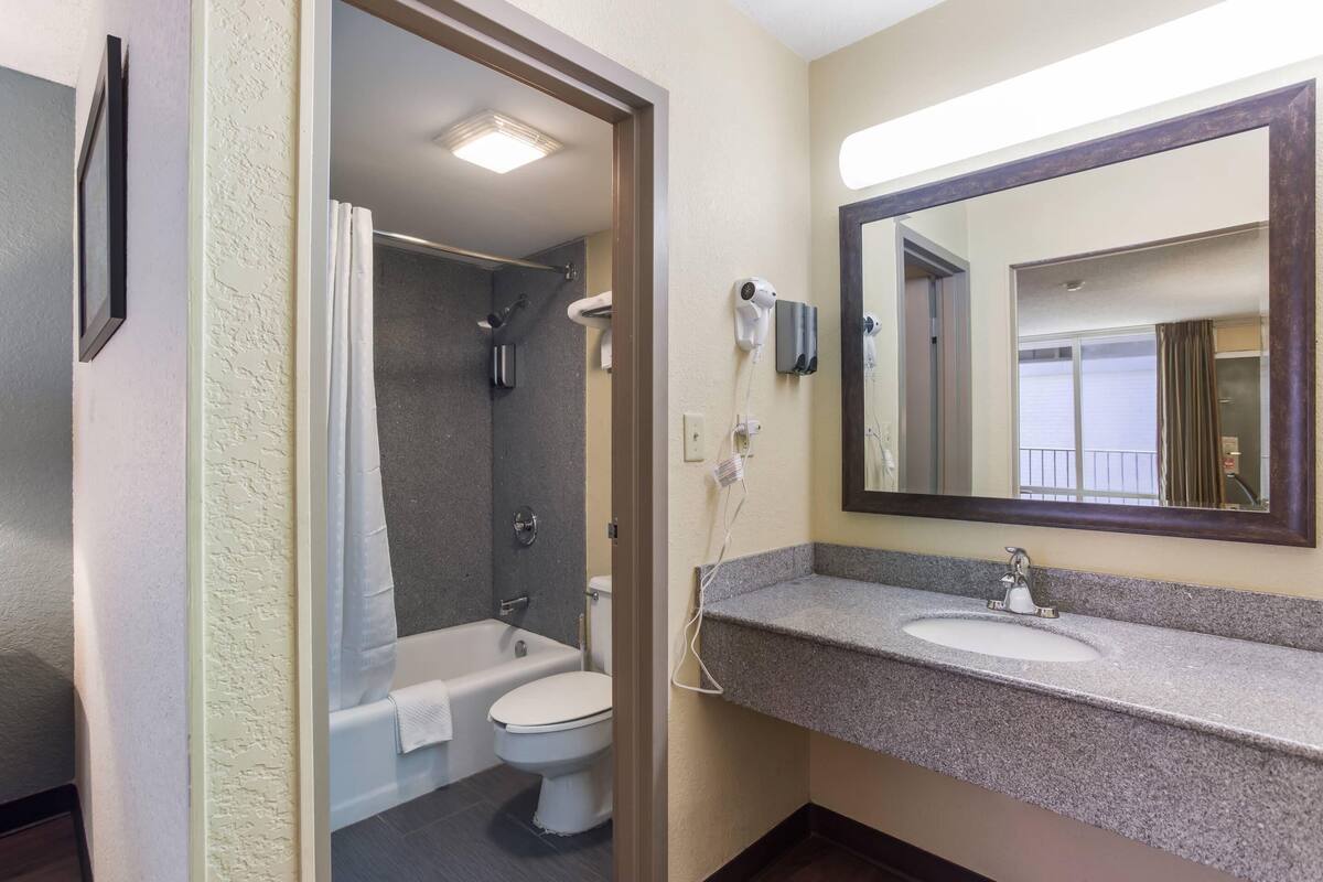 A bathroom with a bathtub, toilet, and sink.