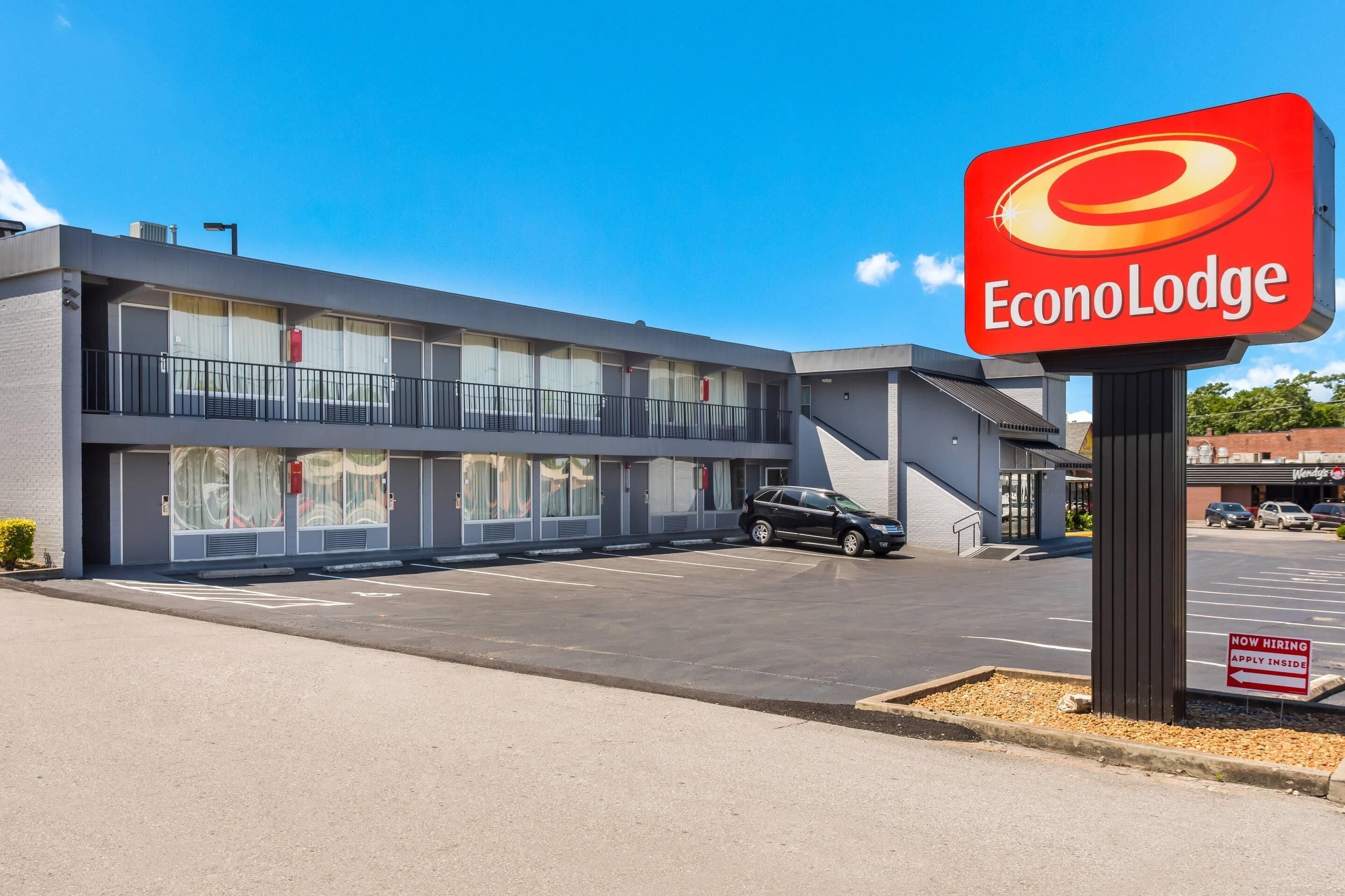 A two-story EconoLodge building with a parking lot in front.