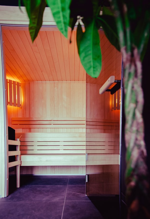 Una sauna con bancos de madera y piso de baldosas.