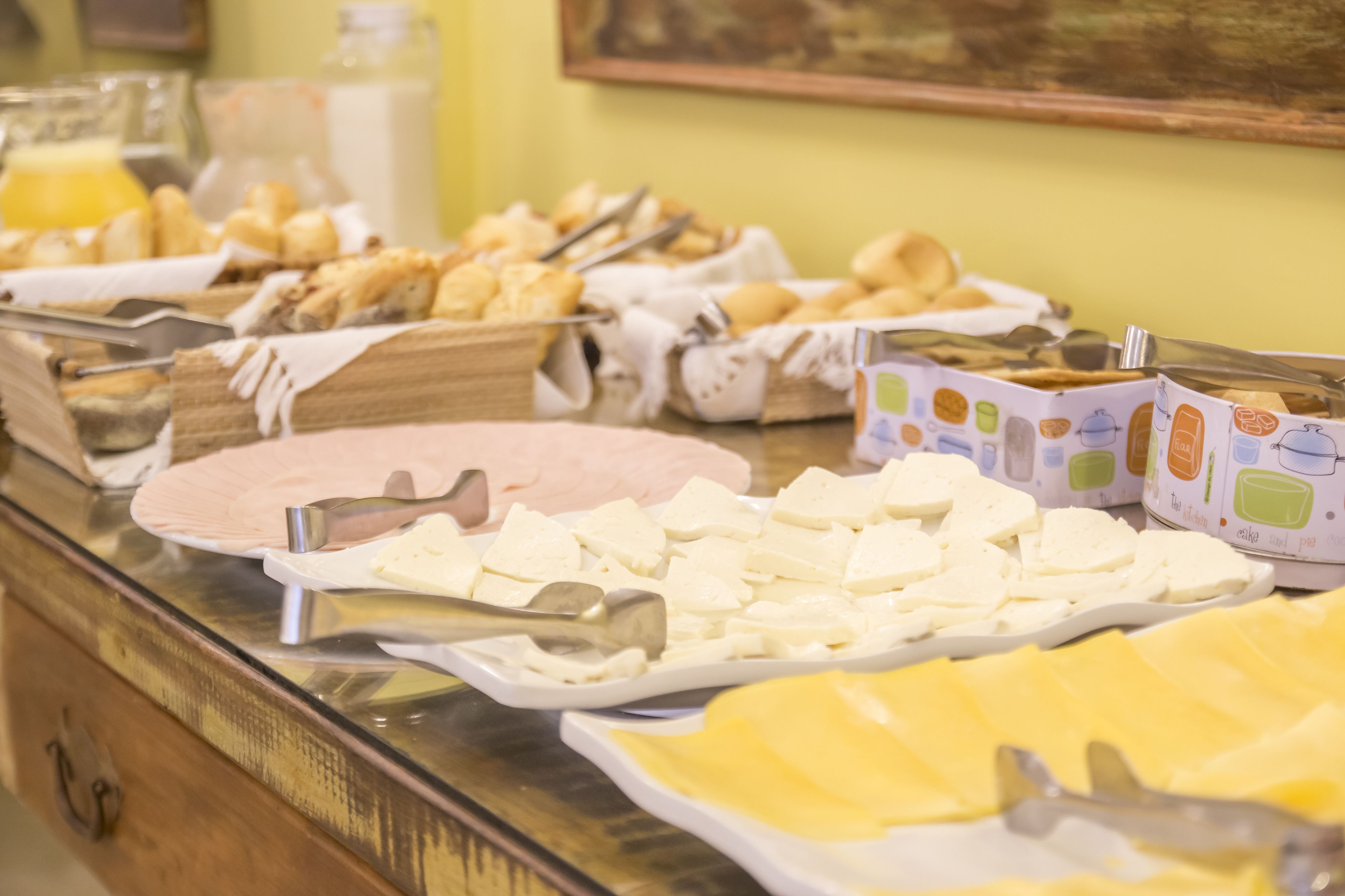 A buffet with various food items and serving utensils.