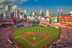 A large stadium with multiple levels of seating and a baseball field.
