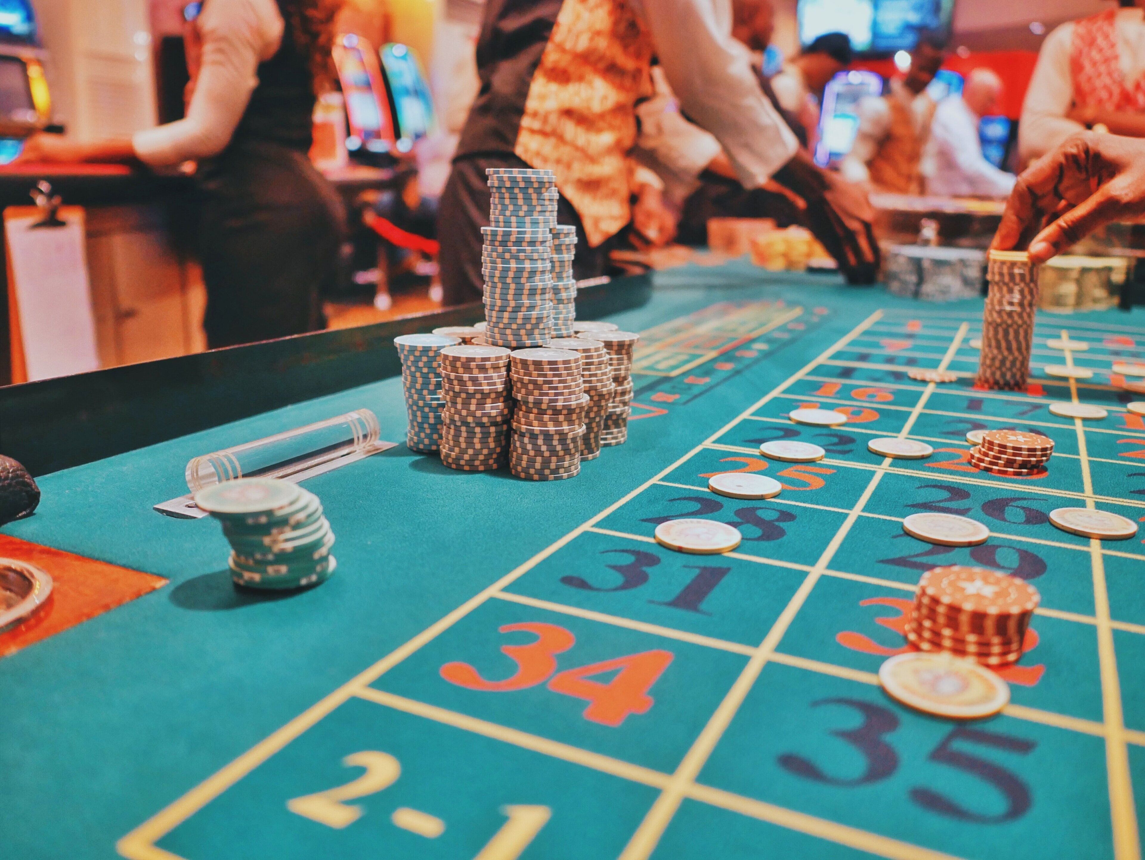 A craps table with stacked chips and betting areas marked with numbers.