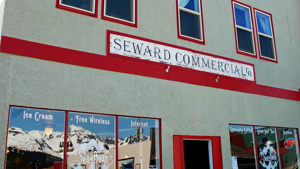 A building with a sign reading "SEWARD COMMERCIALS." - Sauerdough Lodging (Seward)
