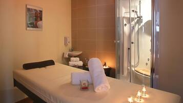 Relax in a serene space with a comfortable bed, modern bathroom, and personal touches.