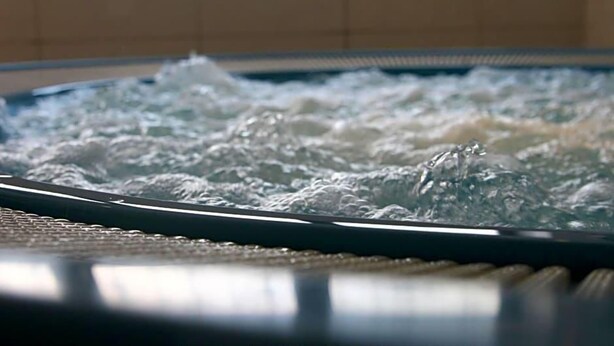 A hot tub with water jets in motion, surrounded by a tiled wall. - Zum Hirschen (Donaueschingen)