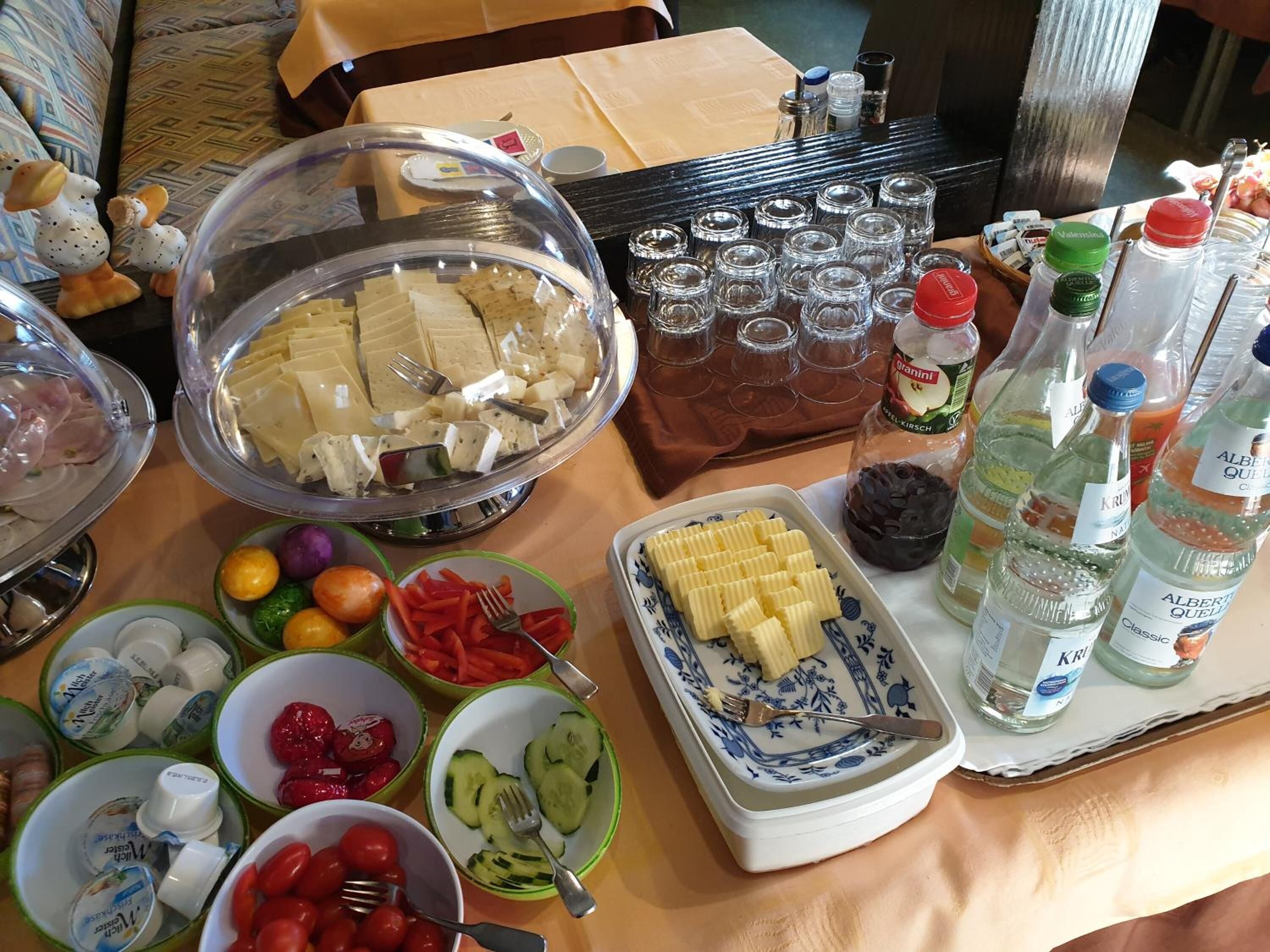 A buffet table with various food items and beverages.