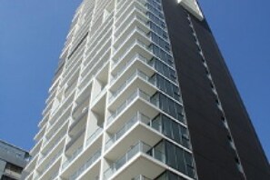 A tall building with a modern design, featuring a series of balconies. - Astra Apartments - Paramatta (Parramatta)