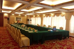 A conference room with a long table, chairs, and a laptop. - Dongguan Hotel (Dongguan)