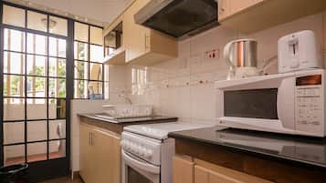 Full-sized fridge, microwave, stovetop, cookware/dishes/utensils