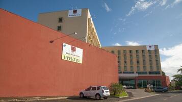 Gran Hotel Arrey features a striking red wall and modern architecture with a flat roof and large windows.