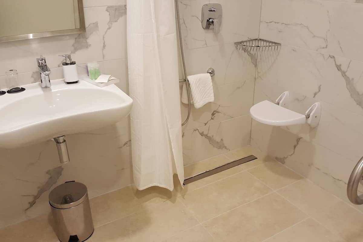classic accessible room | bathroom | free toiletries, hair dryer, bathrobes, slippers