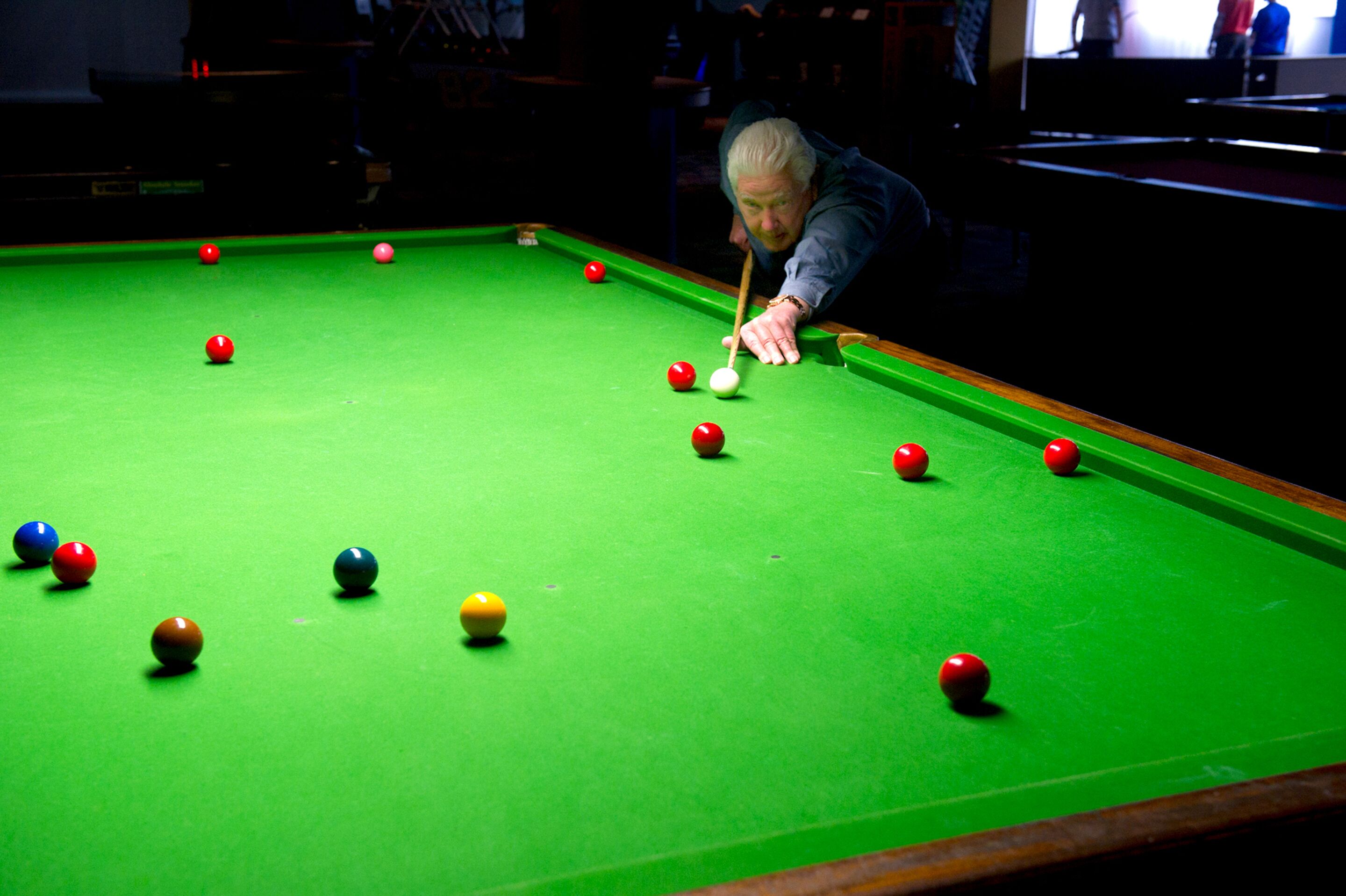 A pool table with balls in various colors.