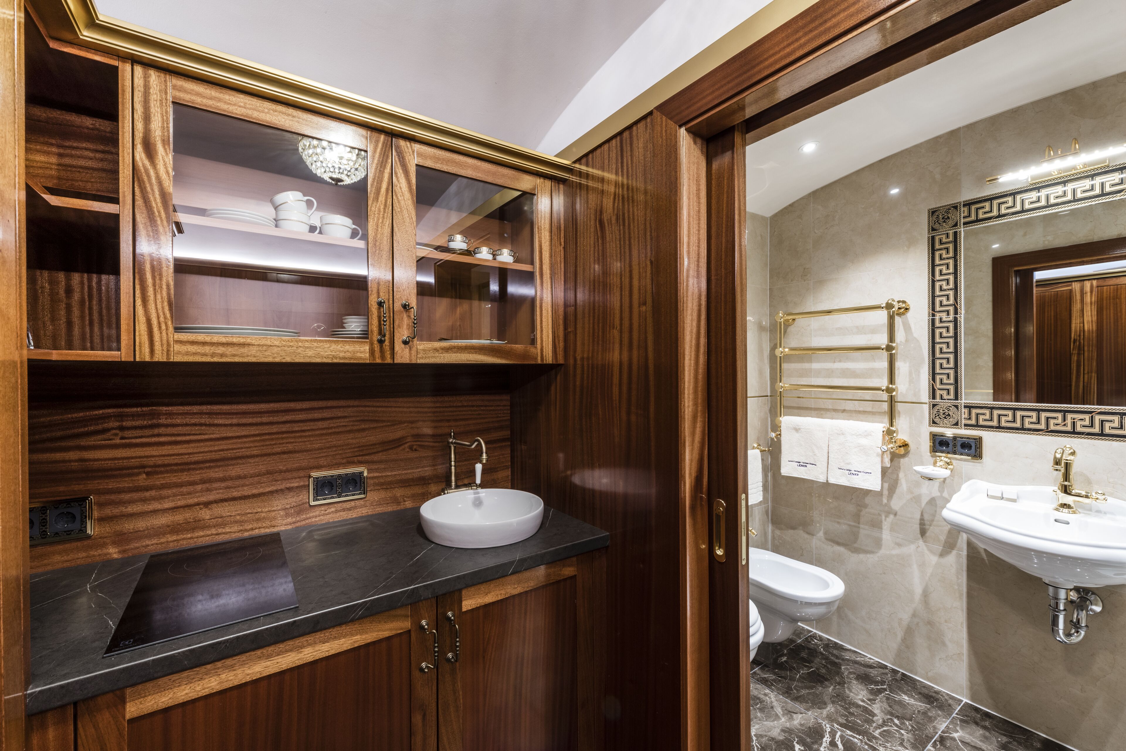 A modern bathroom with a wooden vanity, a sink, and a toilet.