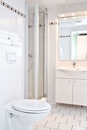 Shower, hair dryer, towels, toilet paper