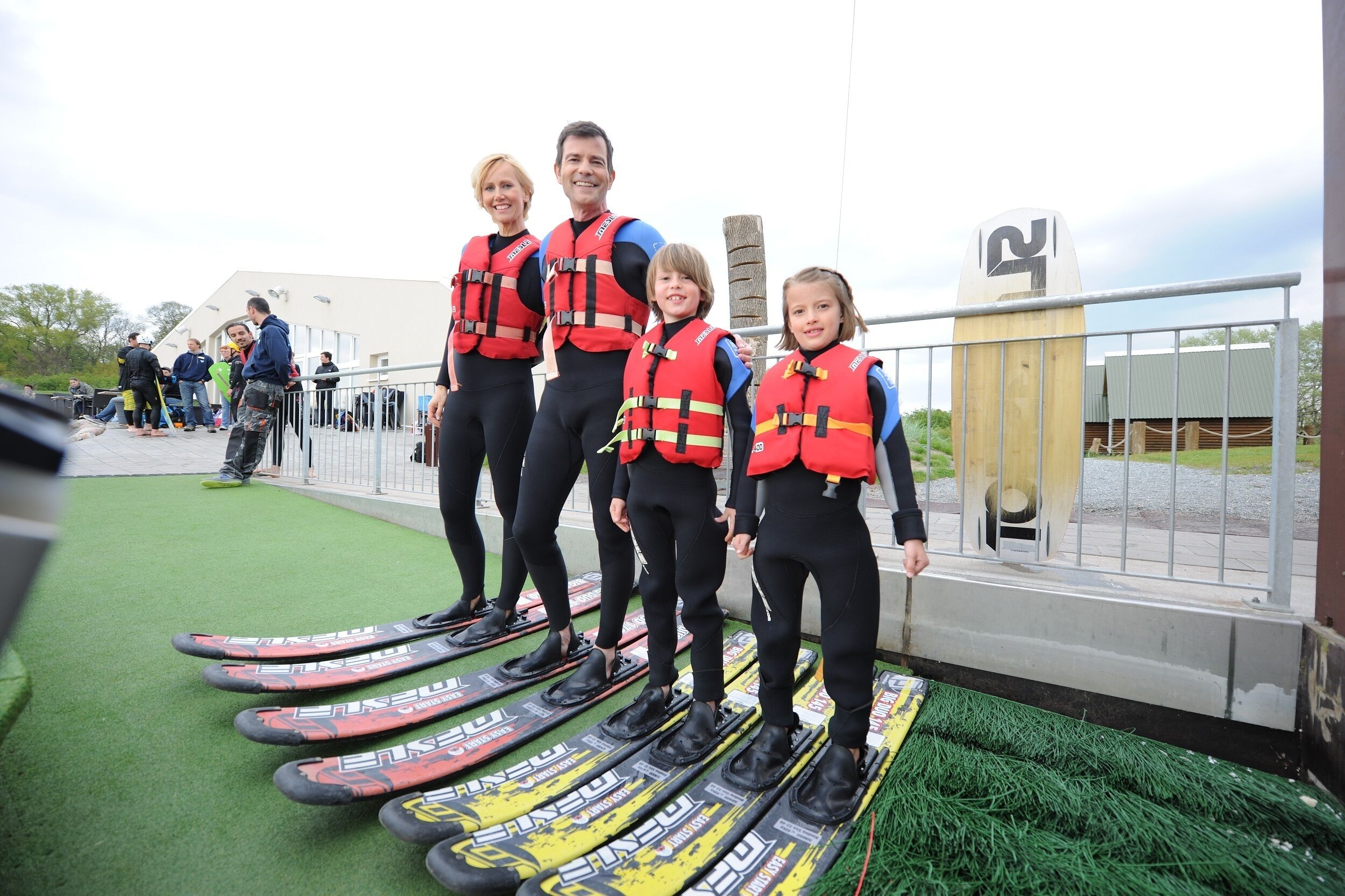 A group of people wearing life jackets and standing on skis.