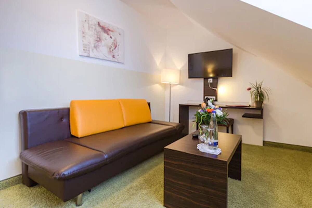 junior suite, multiple beds | living area | flat-screen tv