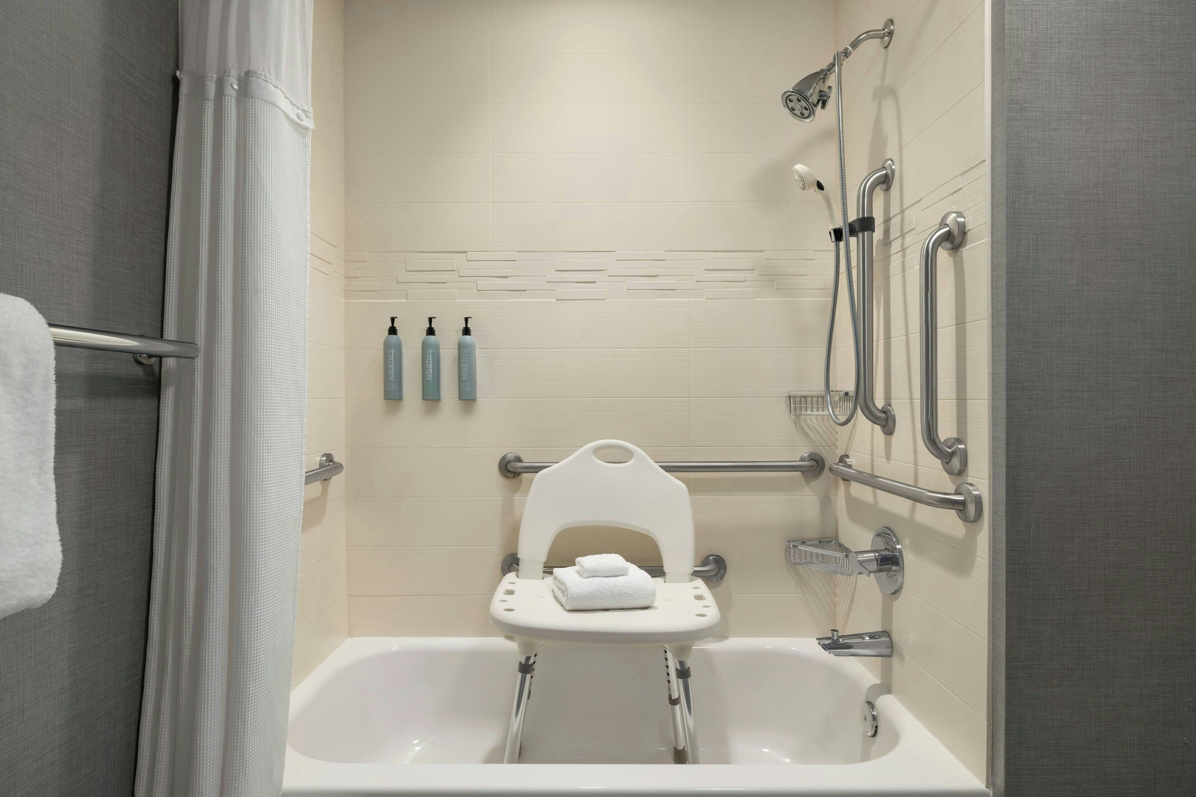 one-bedroom suite, 1 king bed with sofa bed | bathroom | shower, free toiletries, hair dryer, towels