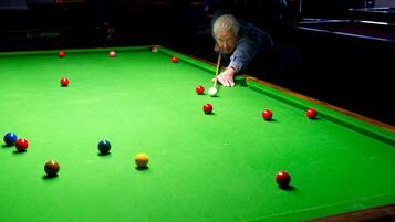 A pool table with balls in various colors.