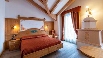 A wooden-framed bedroom with a bed, bedside tables, and a decorative wall piece.