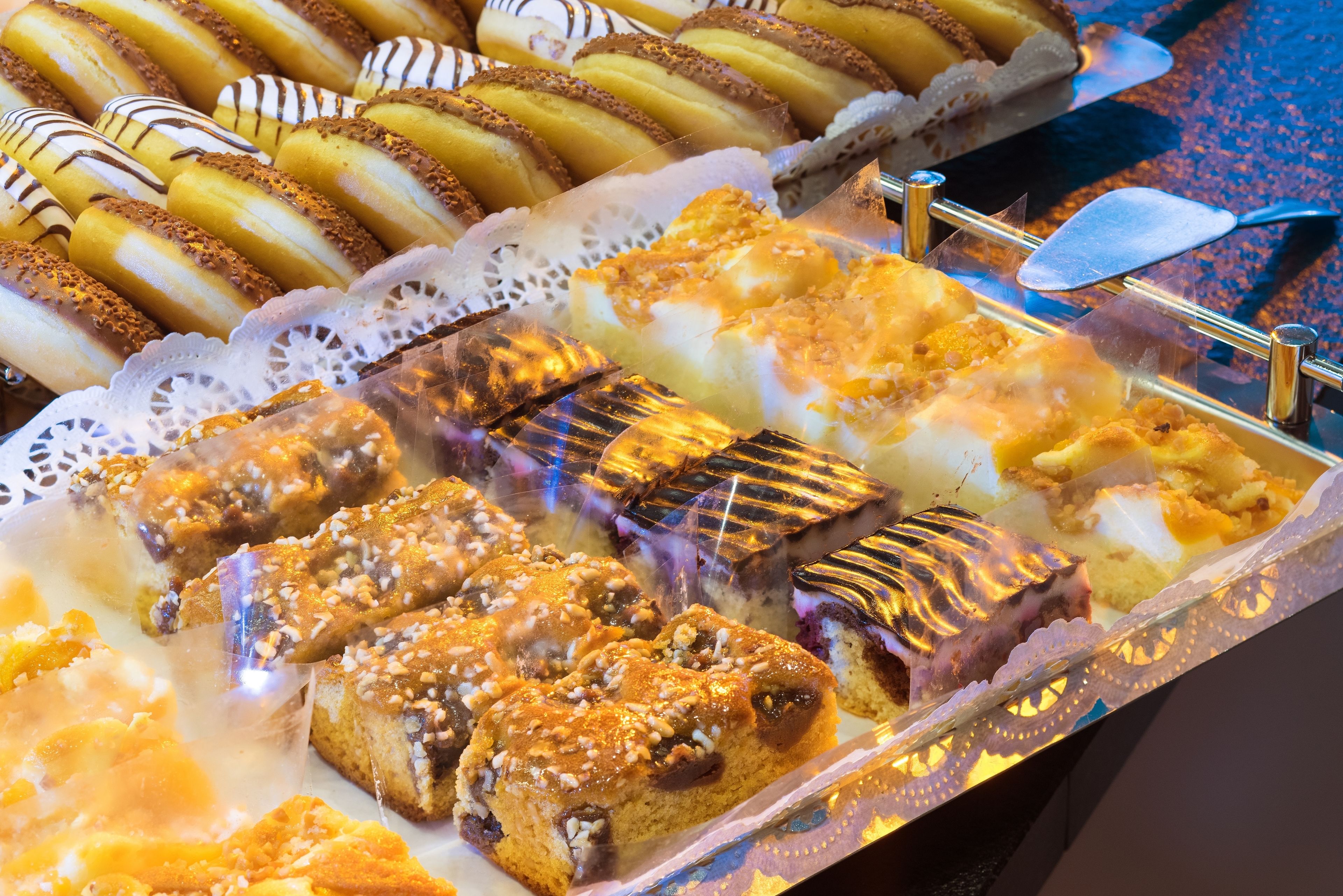 Una bandeja exhibe una variedad de productos horneados, como rosquillas y pasteles.