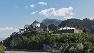 A historic castle on a hill overlooking a river.