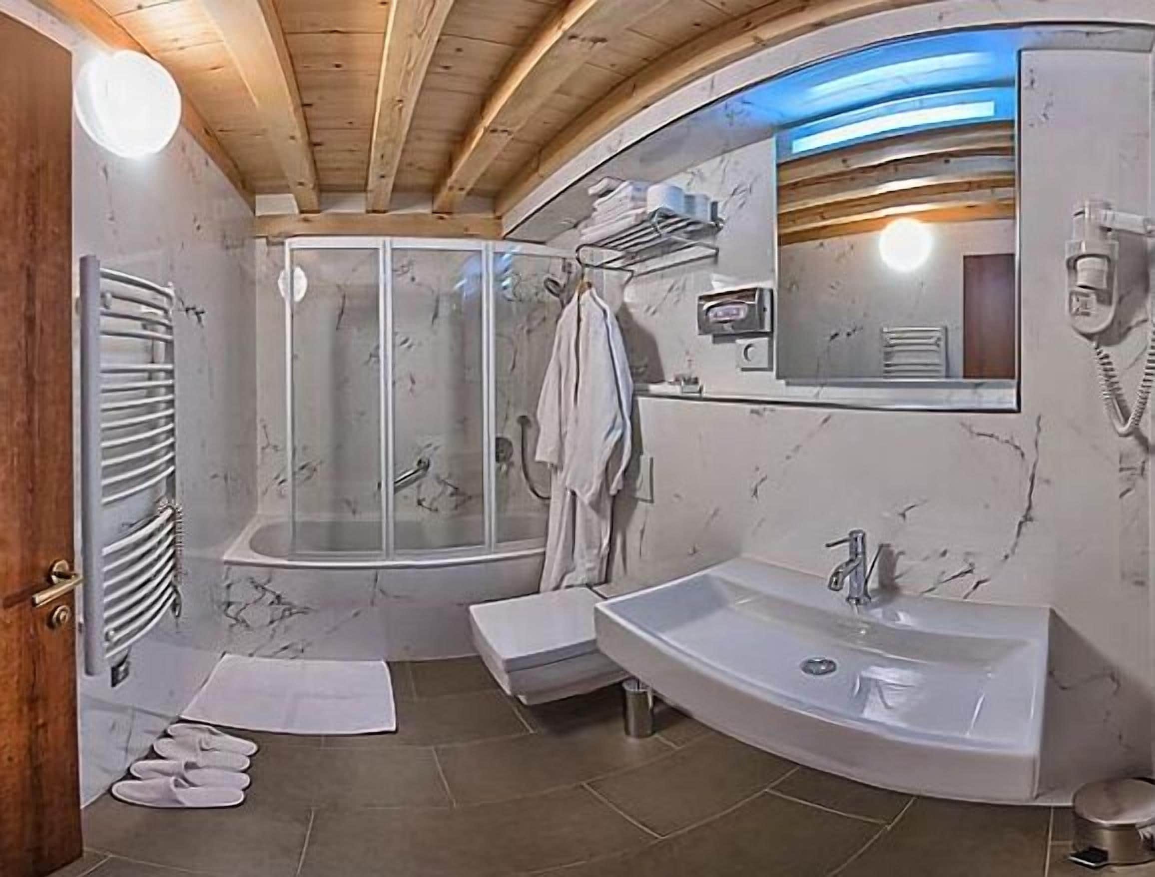 standard double room | bathroom | deep-soaking bathtub, rainfall showerhead, free toiletries, hair dryer