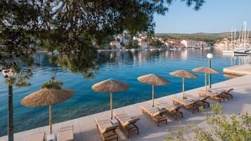 On the beach, sun loungers, beach umbrellas
