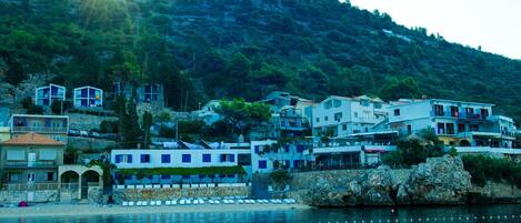 A coastal town with buildings along the waterfront, including a visible 'APARTMANT' sign.