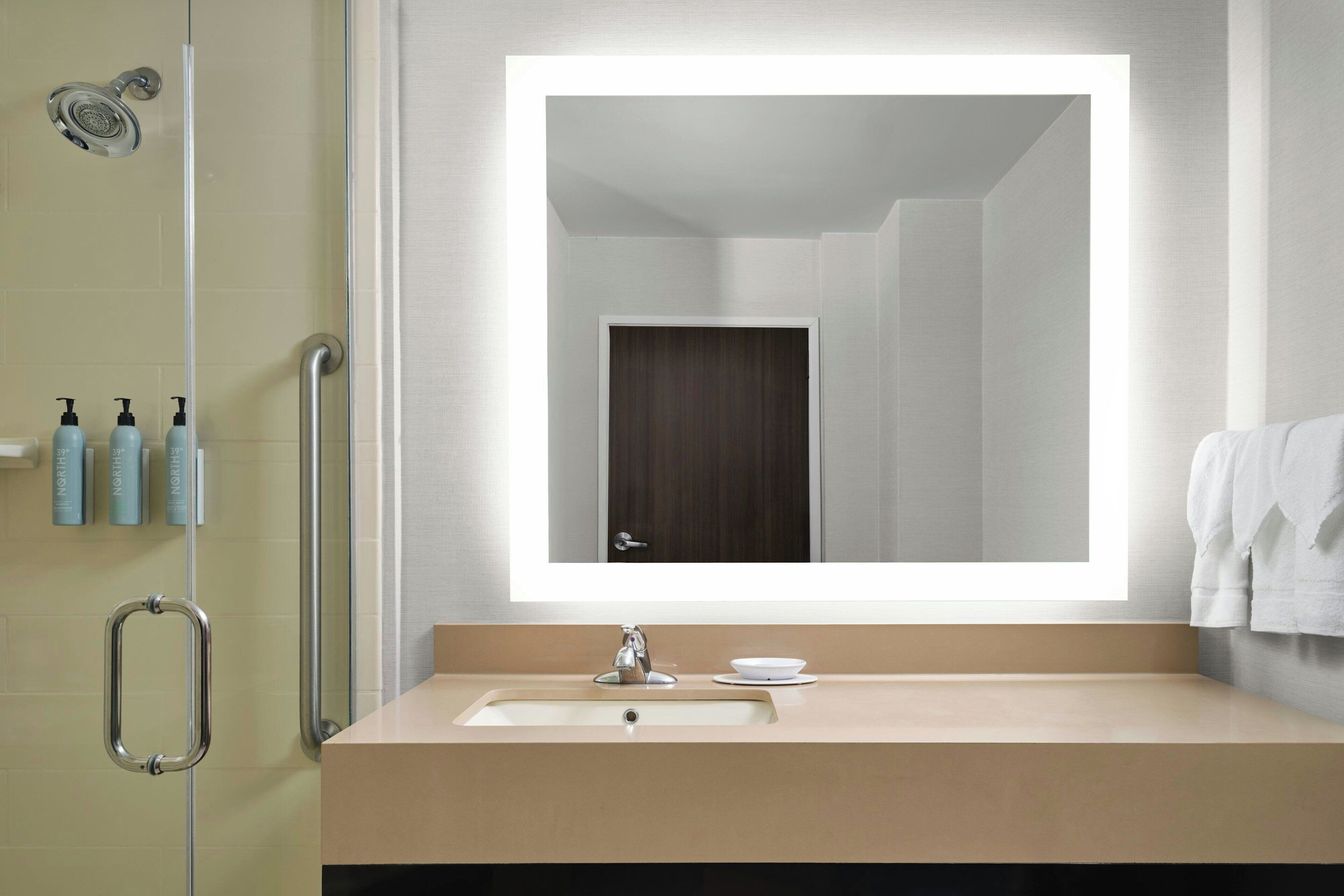 combined shower/bathtub, designer toiletries, hair dryer, towels