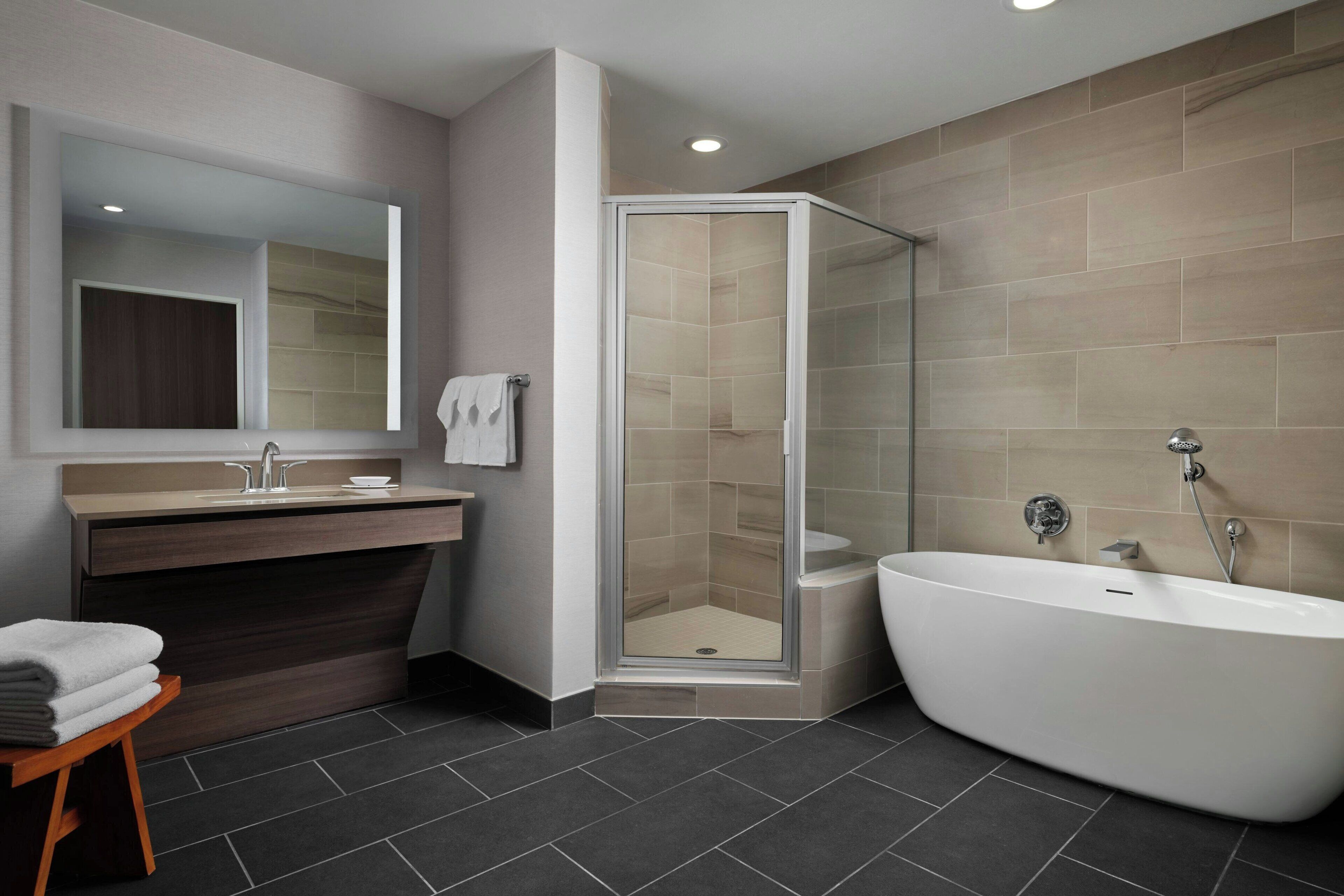 combined shower/bathtub, designer toiletries, hair dryer, towels