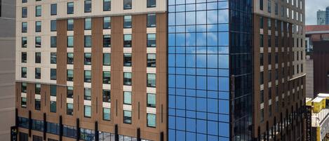 A modern hotel building with a glass facade and the name "Hyatt Place" on the top.