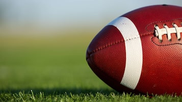 A football on a grassy field.