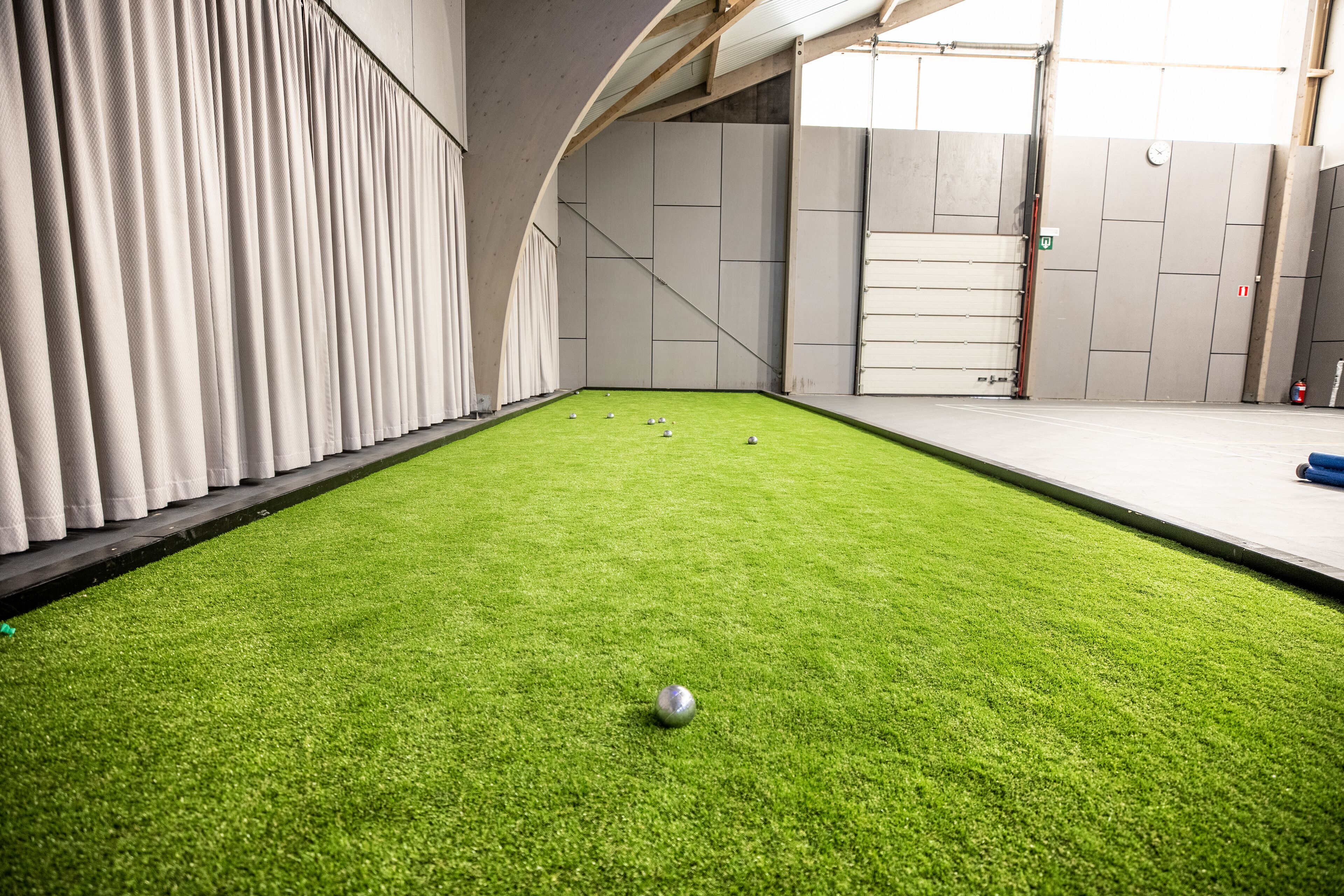 A billiards table with balls and a green felt surface in an indoor setting.