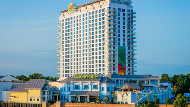 A high-rise hotel with a large sign reading "Margaritaville" and a colorful mural on its side. - Margaritaville Resort Casino (Bossier City)