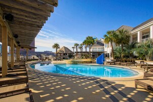 Una piscina al aire libre, sombrillas, tumbonas