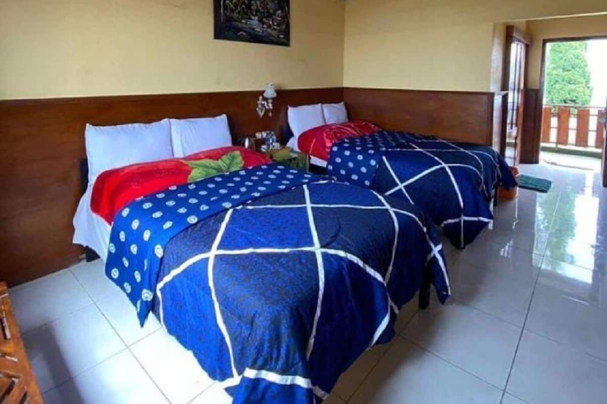 A hotel room with two beds, a wooden headboard, a painting on the wall, and a view of the outdoors.