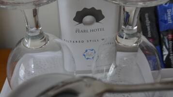 Two glass bottles with red labels, a spoon, and a white box with a logo and text.