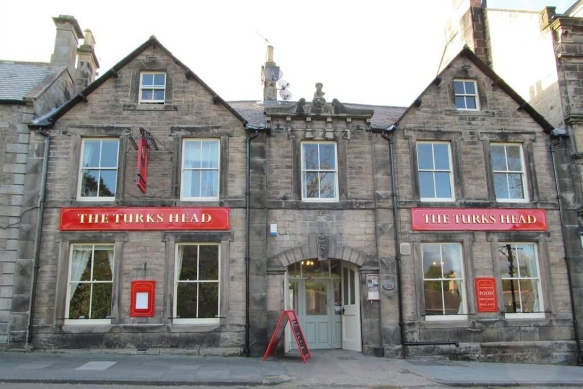 A two-story building with "The Turks Head" signage on both the ground and upper levels.