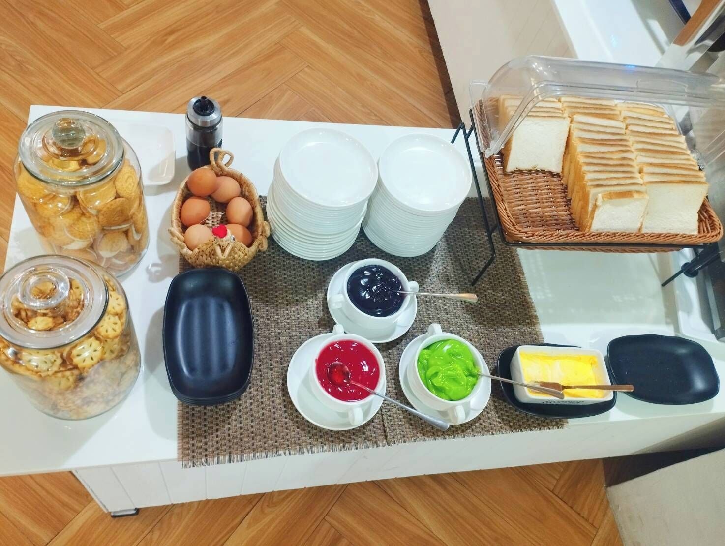 A breakfast buffet with various food items and condiments.
