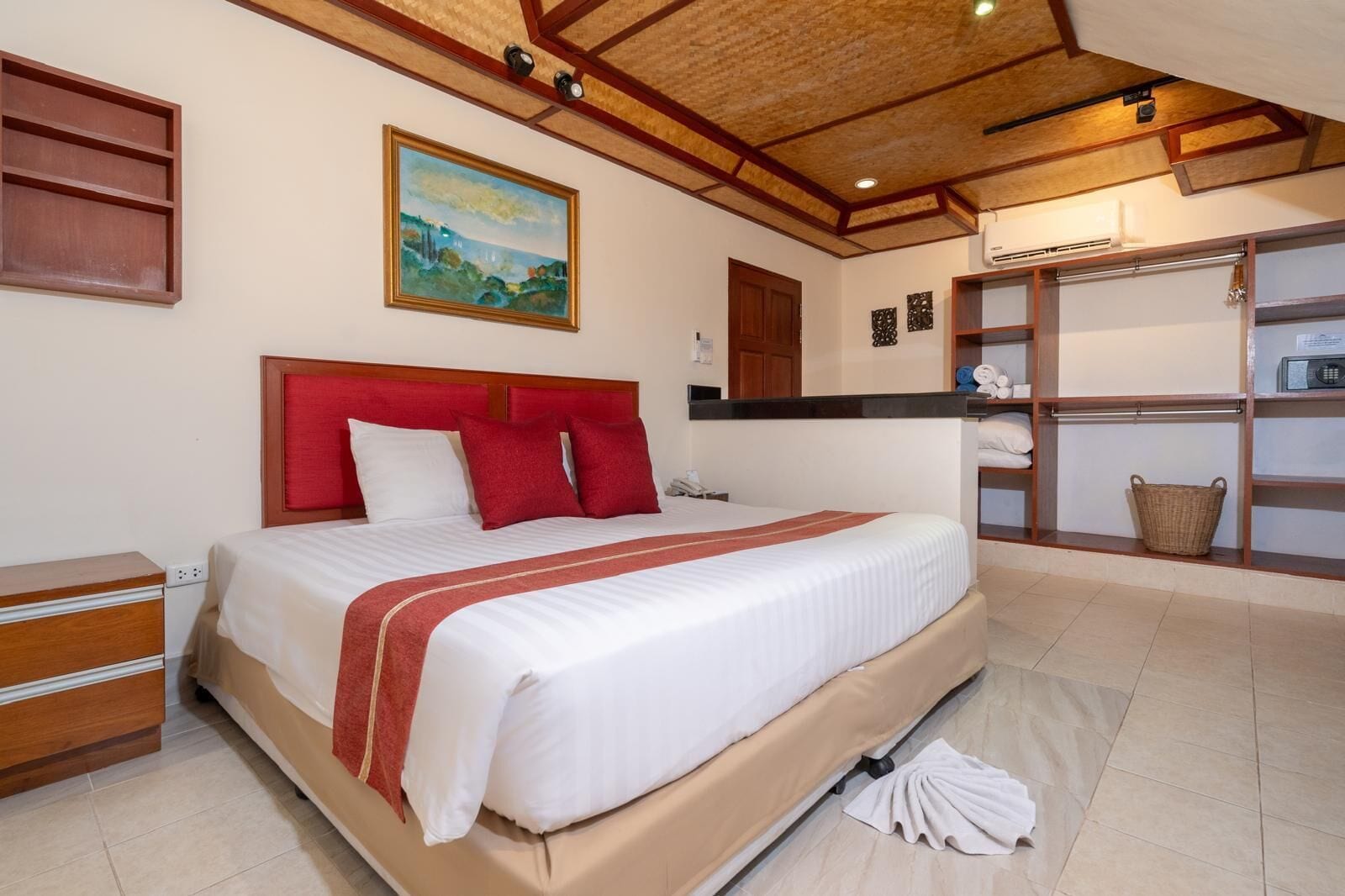 Un dormitorio con una cama grande, cabecera de madera y un cuadro en la pared.
