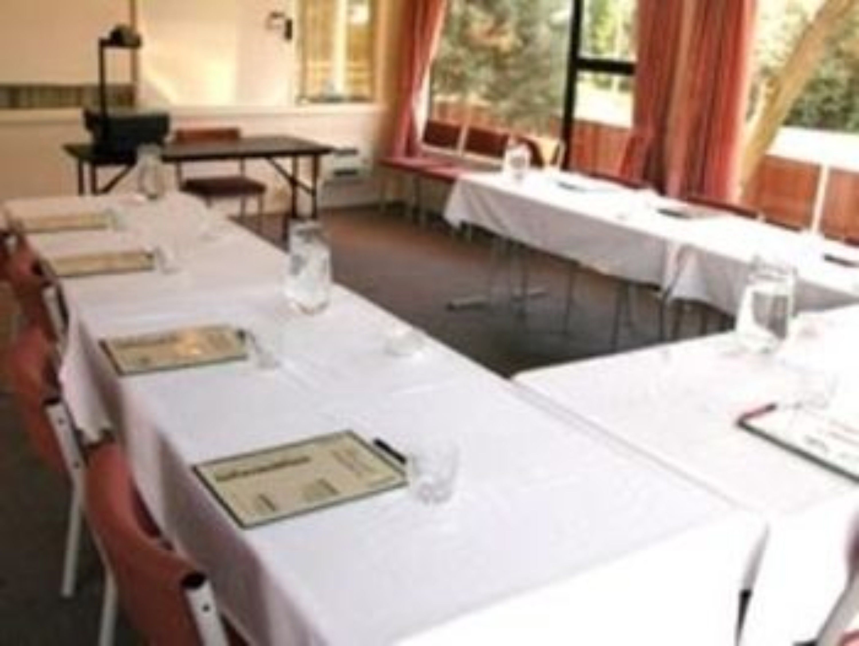 A conference room with long tables set up for a meeting.