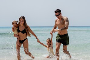 Beach nearby, white sand, beach towels