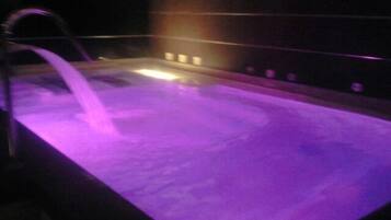 A rectangular pool with a purple light.