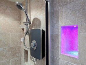 A modern shower with a handheld showerhead and a control panel. - The Kings Arms (Weymouth)