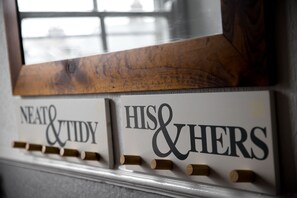 A wall-mounted sign with the words "NEAT & TIDY" and "HIS & HERS" with wooden pegs. - The Lighthorseman (York)