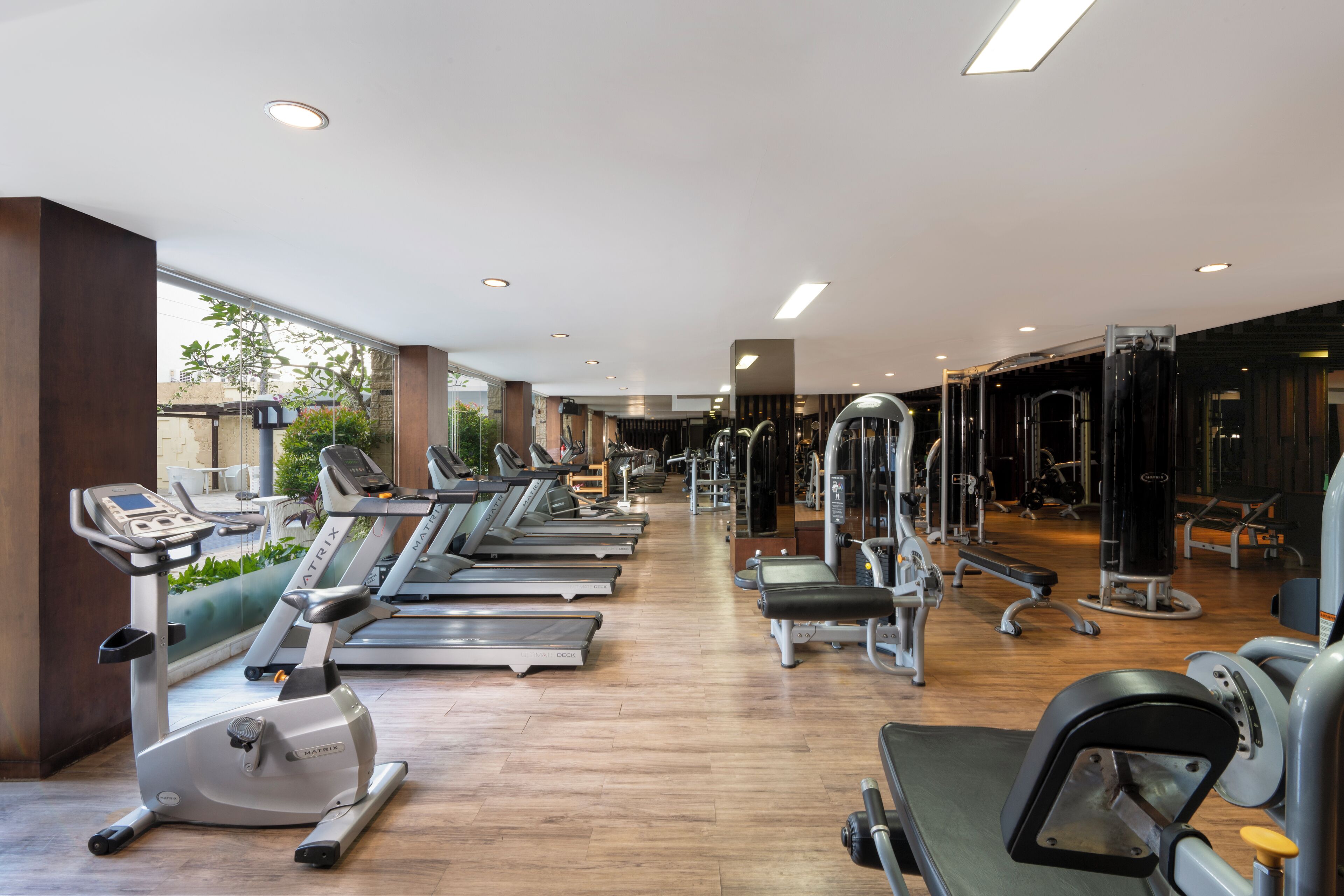 A gym with treadmills, elliptical machines, and weight equipment.