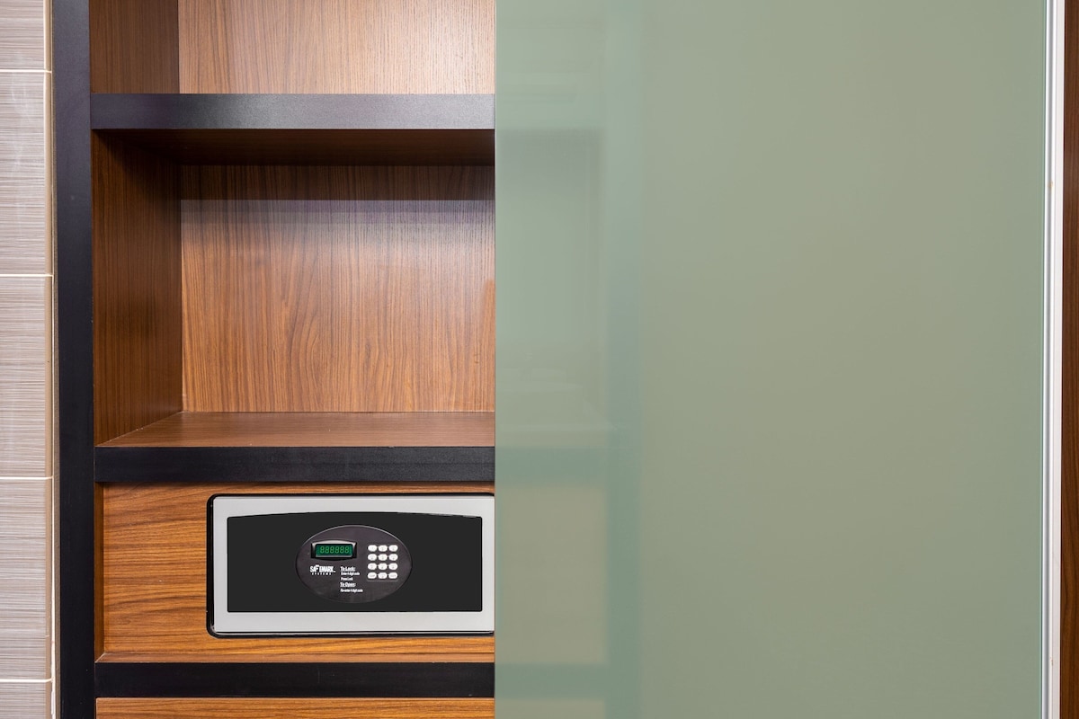 A security keypad with a digital display, a lock mechanism, and a wooden panel.