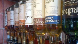 A row of liquor dispensers with various brand labels. - Aurora Hotel & Italian Restaurant (Nairn)