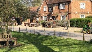A traditional brick building with a sign reading "The Bull Inn." - The Bull Inn Pub (Reading)