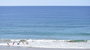 A beach with people surfing and swimming. - Beachside Holiday Apartments (Port Macquarie)